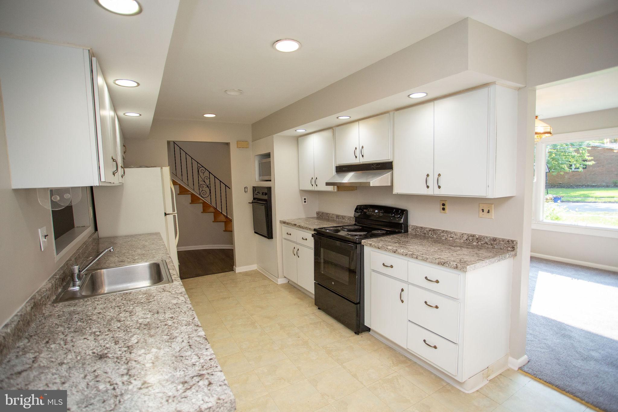 1016 Eagle Lane Cherry Hill, NJ 08003 - Photo 10 of 54 a kitchen with stainless steel appliances granite countertop a stove a sink and a refrigerator