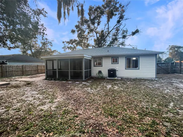 a view of a livingroom with wooden floor and furniture