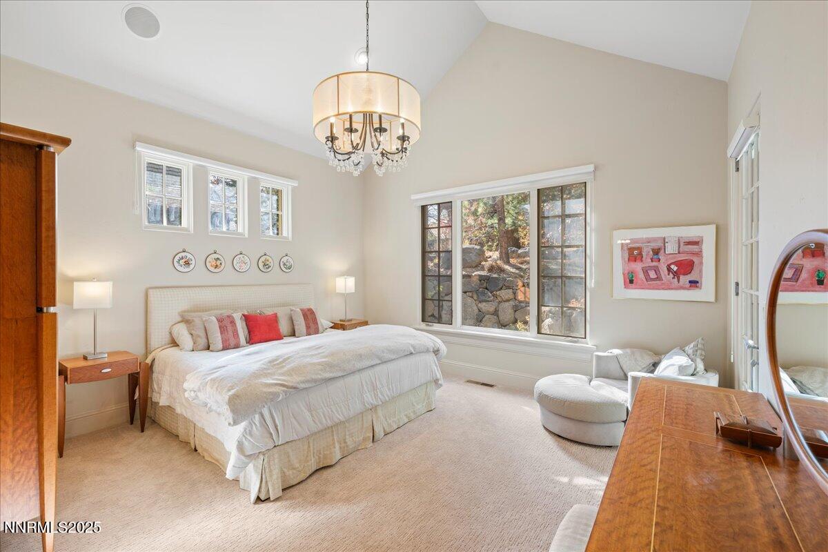 6355 Wetzel Court Reno, NV 89511 - Photo 15 of 38 a bedroom with a bed and a chandelier