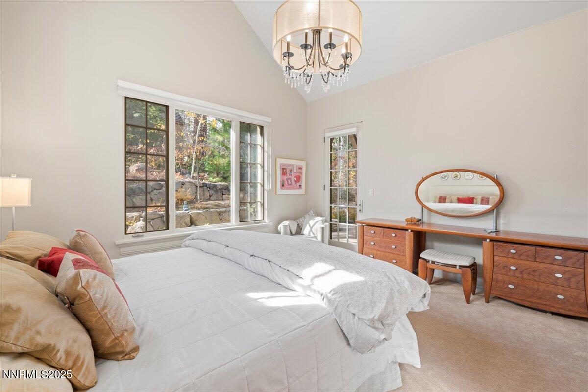 6355 Wetzel Court Reno, NV 89511 - Photo 16 of 38 a bedroom with a bed and a chandelier