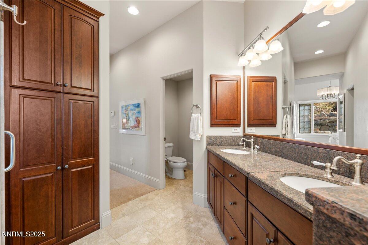 6355 Wetzel Court Reno, NV 89511 - Photo 18 of 38 a spacious bathroom with a granite countertop sink and mirror