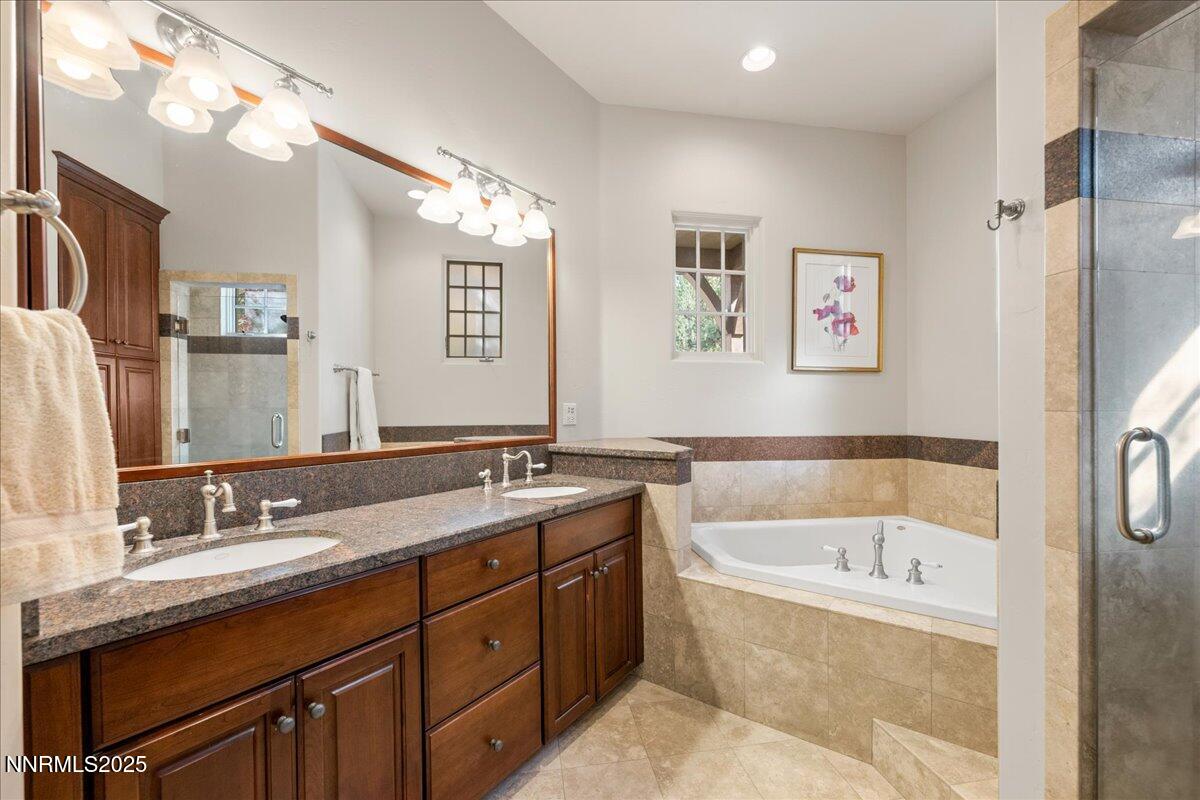 6355 Wetzel Court Reno, NV 89511 - Photo 19 of 38 a bathroom with a tub a double vanity sink and mirror