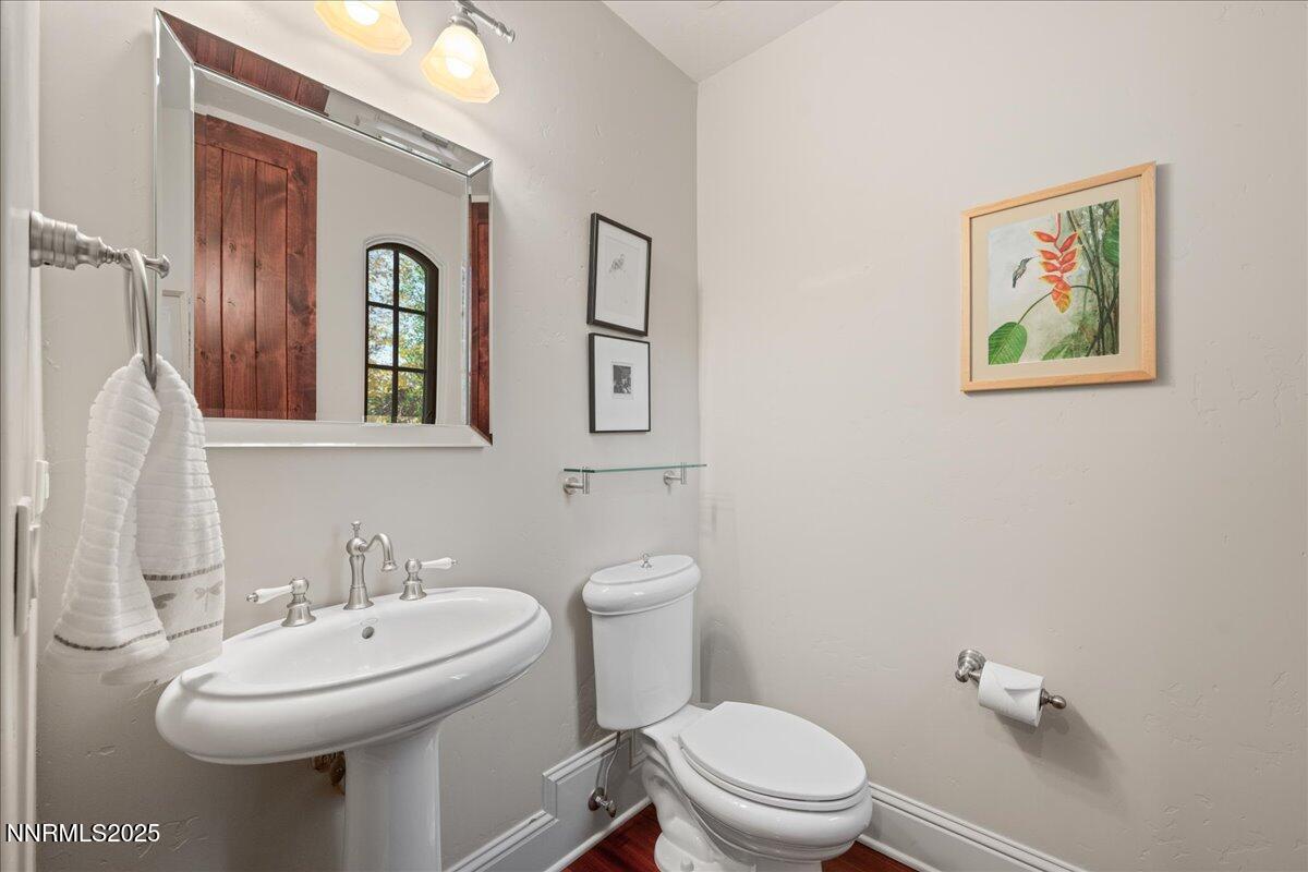 6355 Wetzel Court Reno, NV 89511 - Photo 28 of 38 a bathroom with a toilet sink and mirror