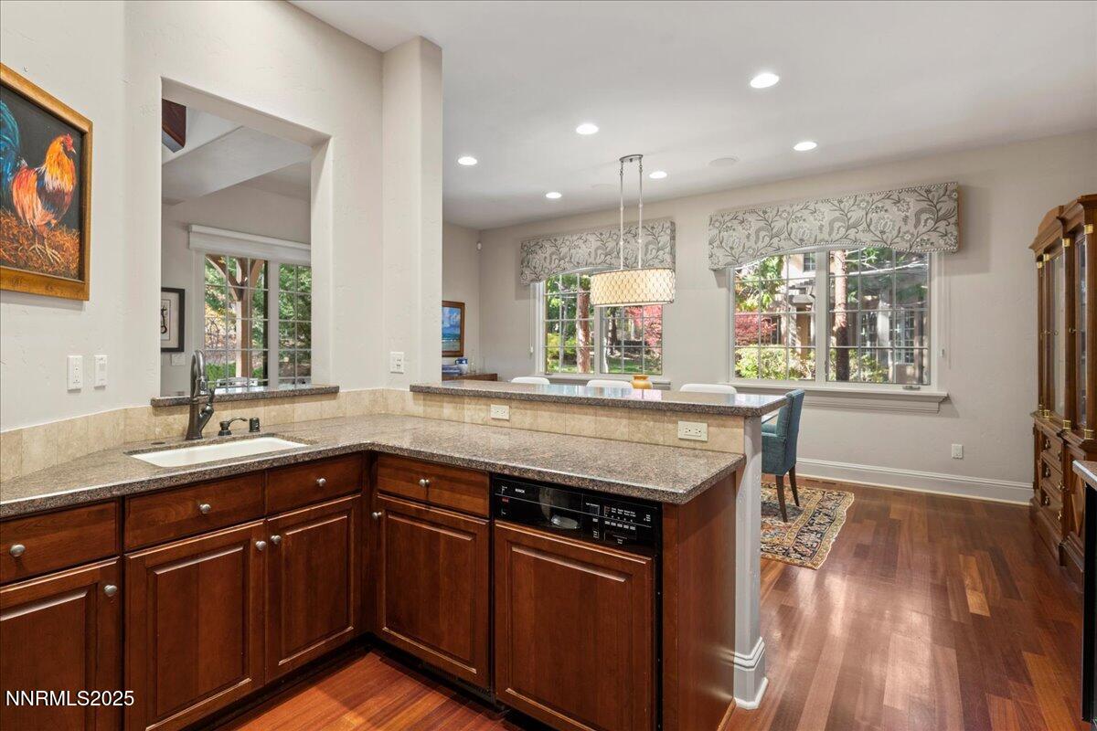 6355 Wetzel Court Reno, NV 89511 - Photo 9 of 38 a kitchen with a sink dishwasher a stove and a refrigerator with wooden floor