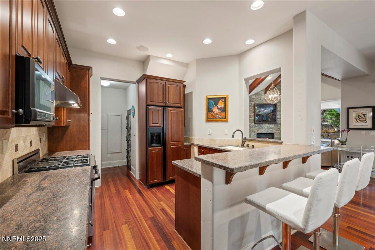 6355 Wetzel Court Reno, NV 89511 - Photo 10 of 38 a dining hall with stainless steel appliances granite countertop a refrigerator and a sink
