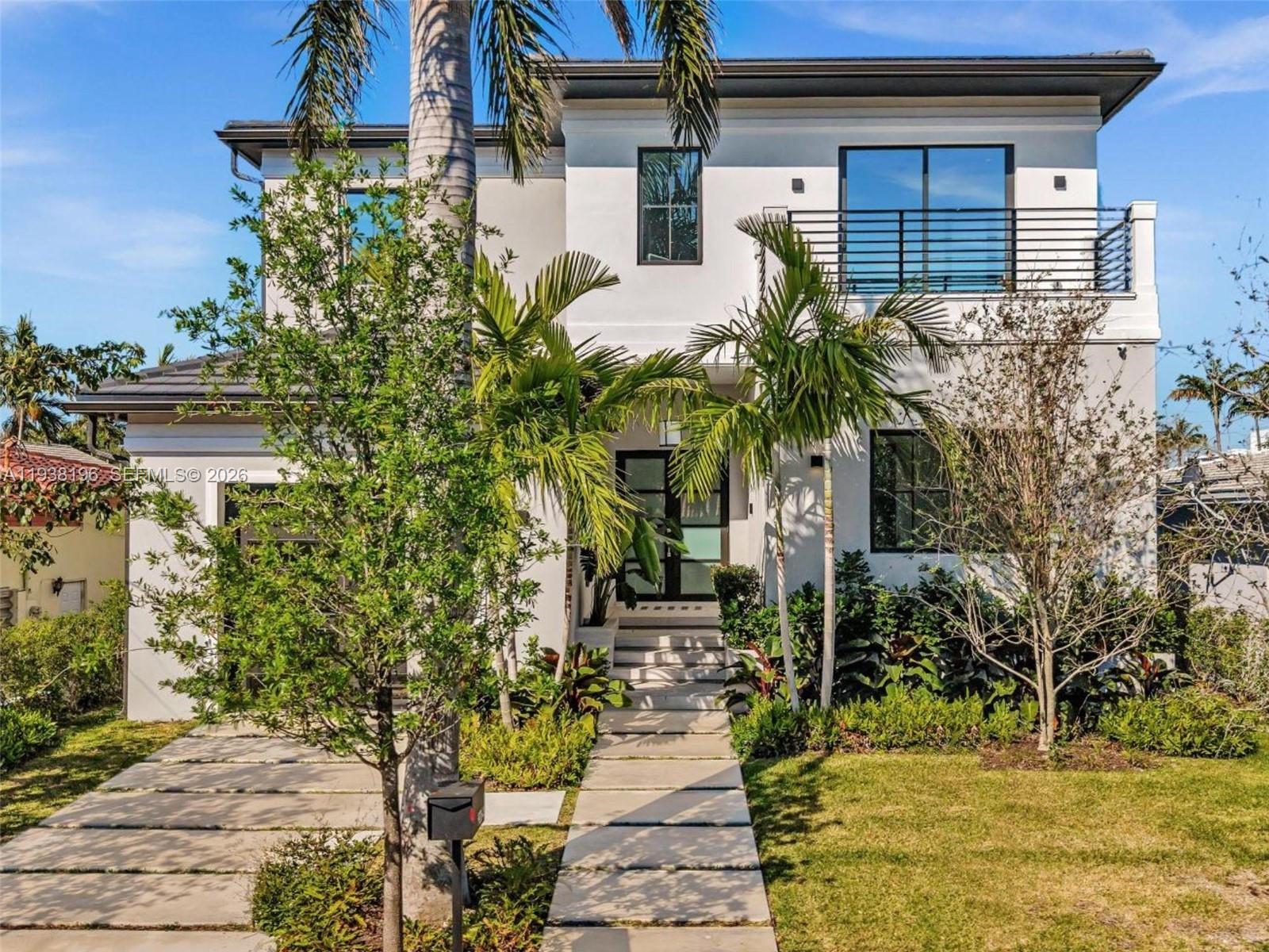 9264 Dickens Avenue Surfside, FL 33154 - Photo 1 of 46 a front view of a house with a yard