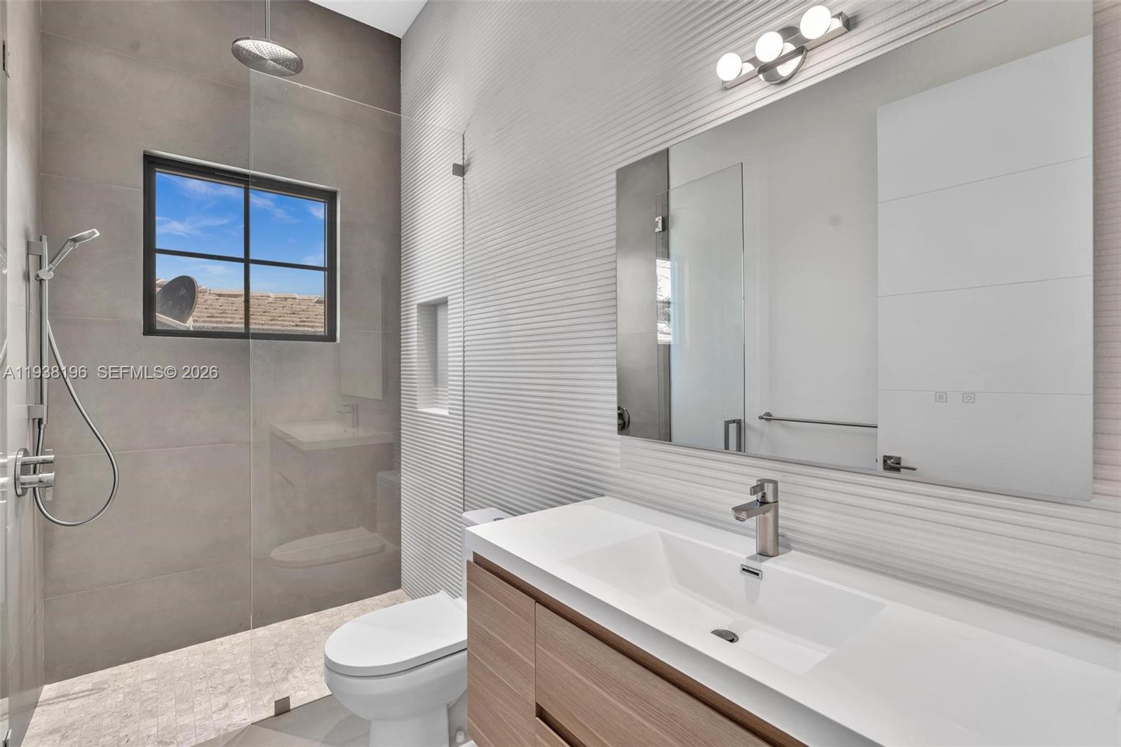 9264 Dickens Avenue Surfside, FL 33154 - Photo 17 of 46 a bathroom with a sink a toilet and shower