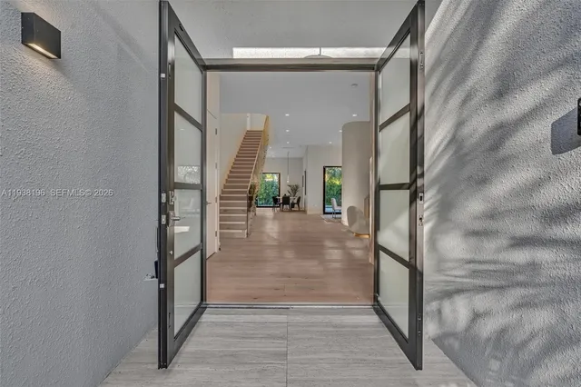 a view of entryway and hall with wooden floor