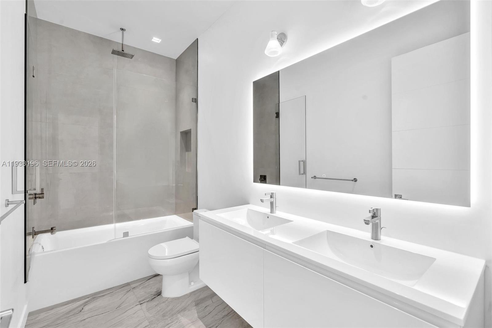 9264 Dickens Avenue Surfside, FL 33154 - Photo 22 of 46 a bathroom with a sink toilet and shower