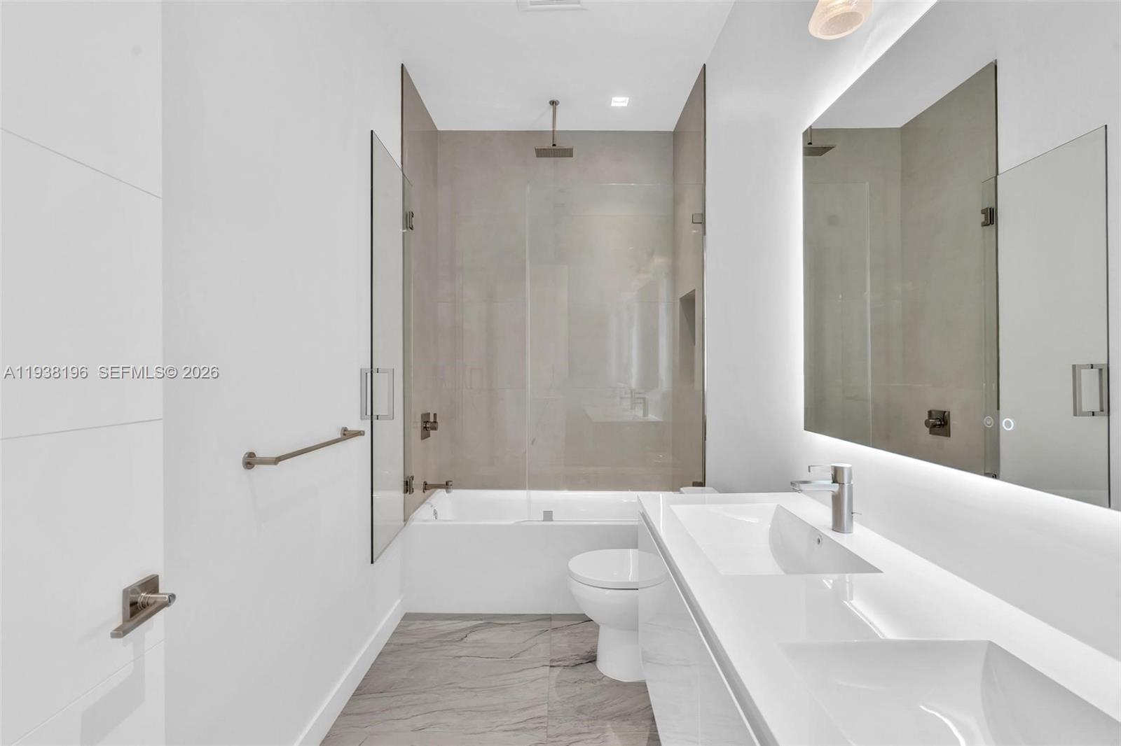 9264 Dickens Avenue Surfside, FL 33154 - Photo 23 of 46 a bathroom with a bathtub shower sink and toilet