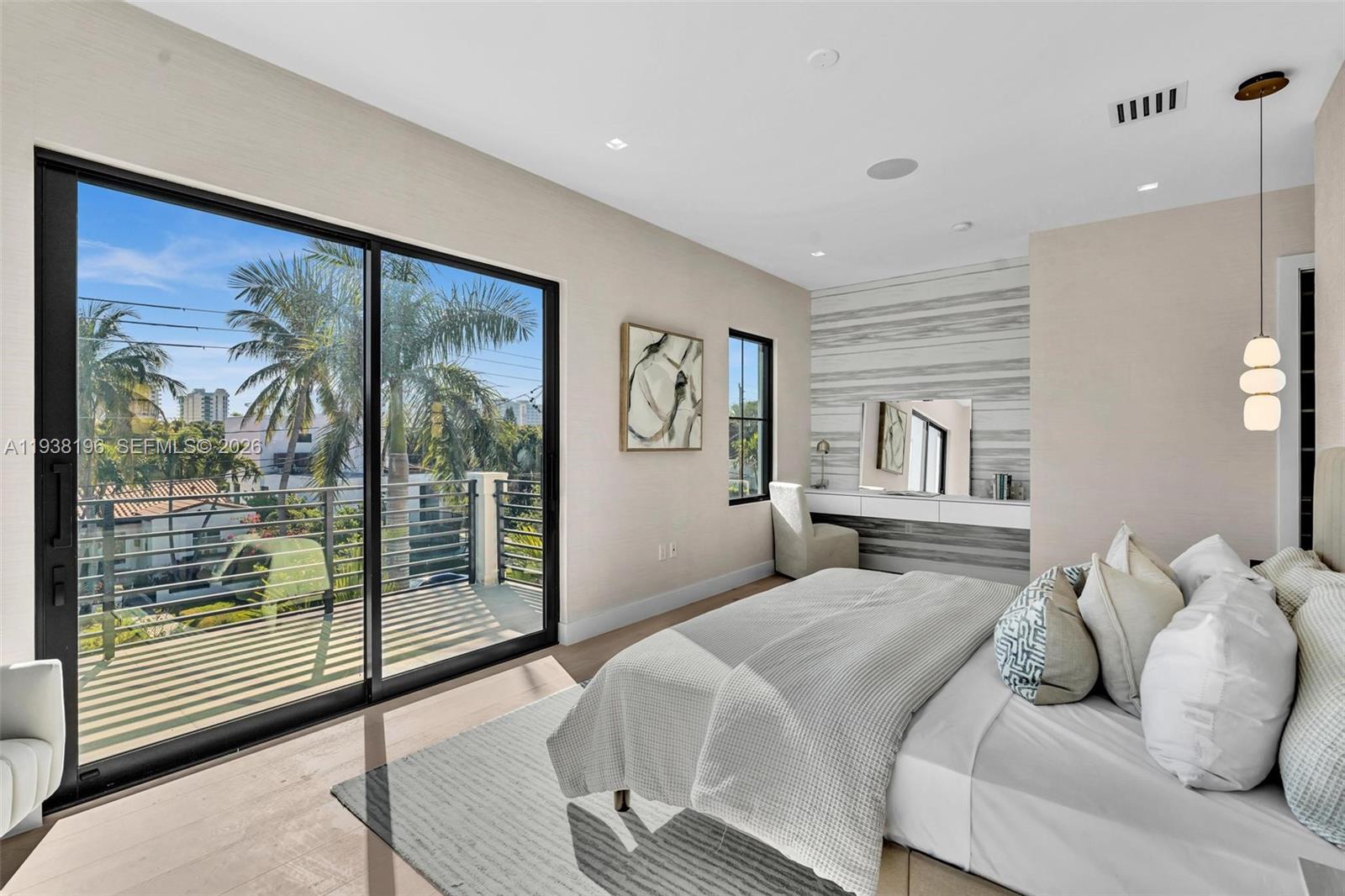 9264 Dickens Avenue Surfside, FL 33154 - Photo 28 of 46 a bedroom with a large bed and a painting on the wall