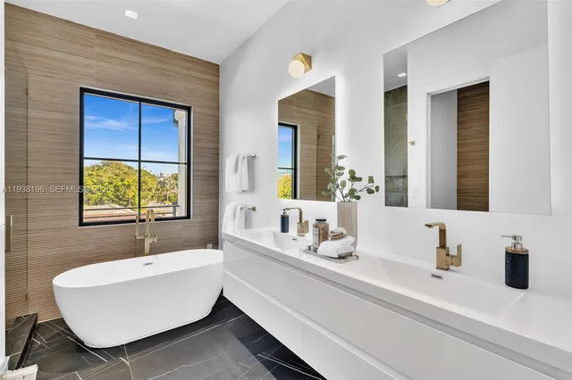 a bathroom with a granite countertop sink a toilet and a tub