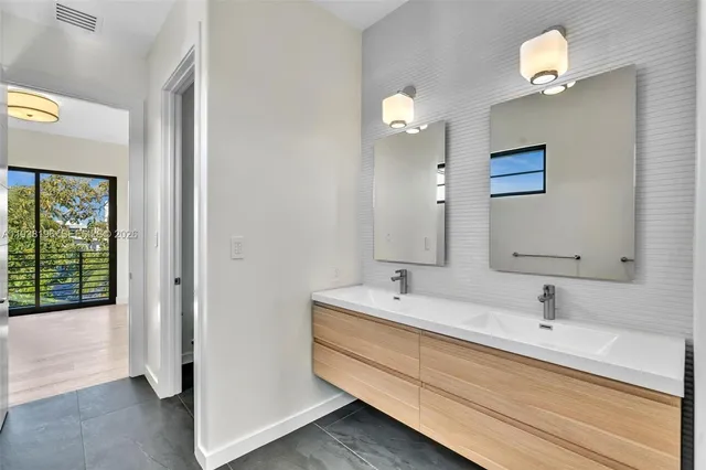 an empty room with a window and cabinet