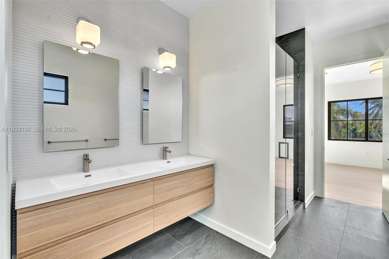 9264 Dickens Avenue Surfside, FL 33154 - Photo 39 of 46 a bathroom with a double vanity sink and a mirror