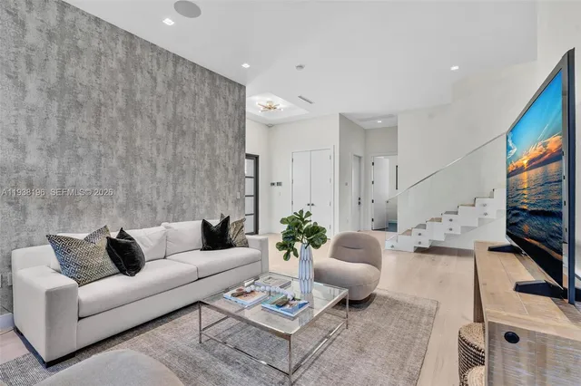 a living room with furniture and a flat screen tv