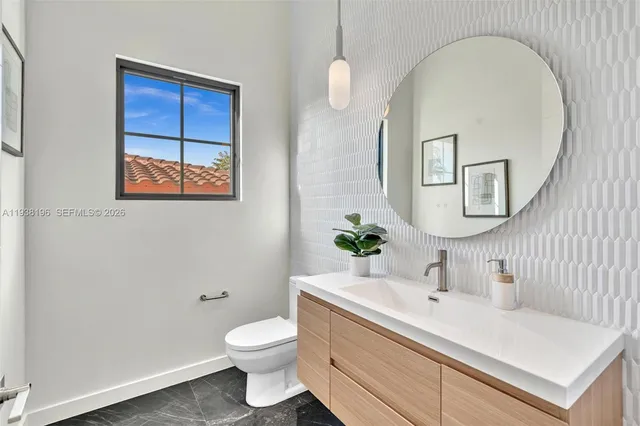 a kitchen with stainless steel appliances granite countertop a sink a stove and a wooden floors