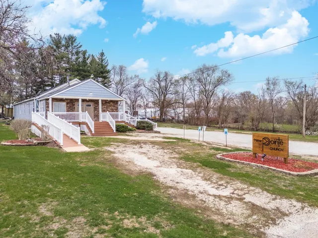 a view of a house with backyard and sitting area