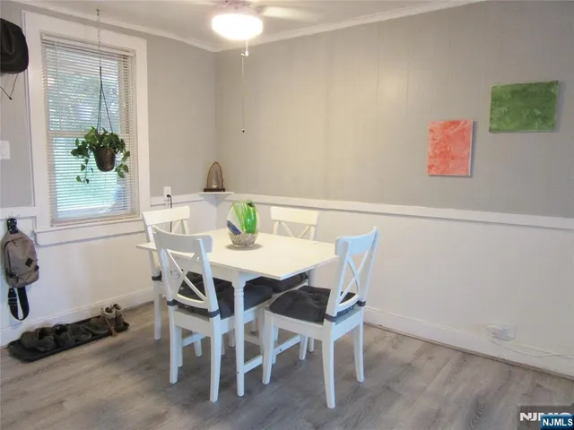 a view of a dining room with furniture and window