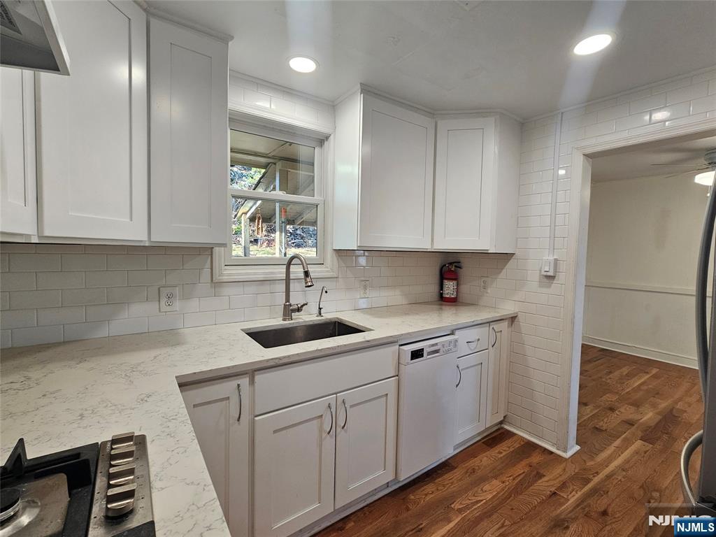 95 Cannonball Road Pompton Lakes, NJ 07442 - Photo 2 of 18 a kitchen with sink cabinets and wooden floor