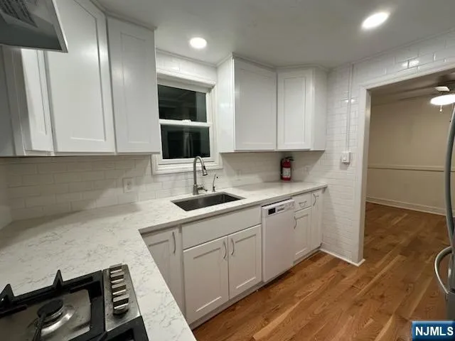 a kitchen with sink cabinets and stove top oven