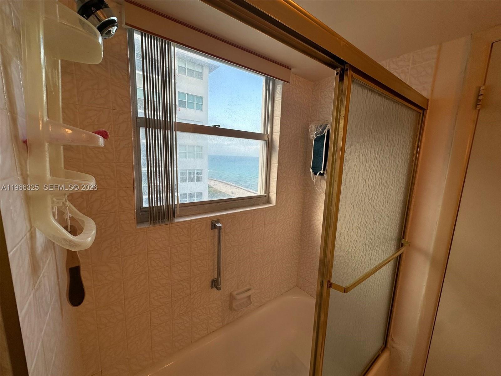 6039 Collins Avenue, Unit 1517 Miami Beach, FL 33140 - Photo 11 of 54 a bathroom with a mirror
