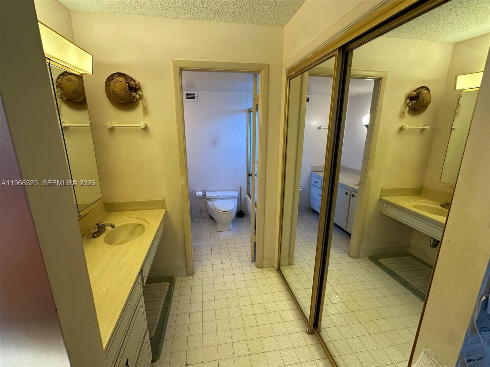 6039 Collins Avenue, Unit 1517 Miami Beach, FL 33140 - Photo 12 of 54 a bathroom with a tub a sink and a mirror