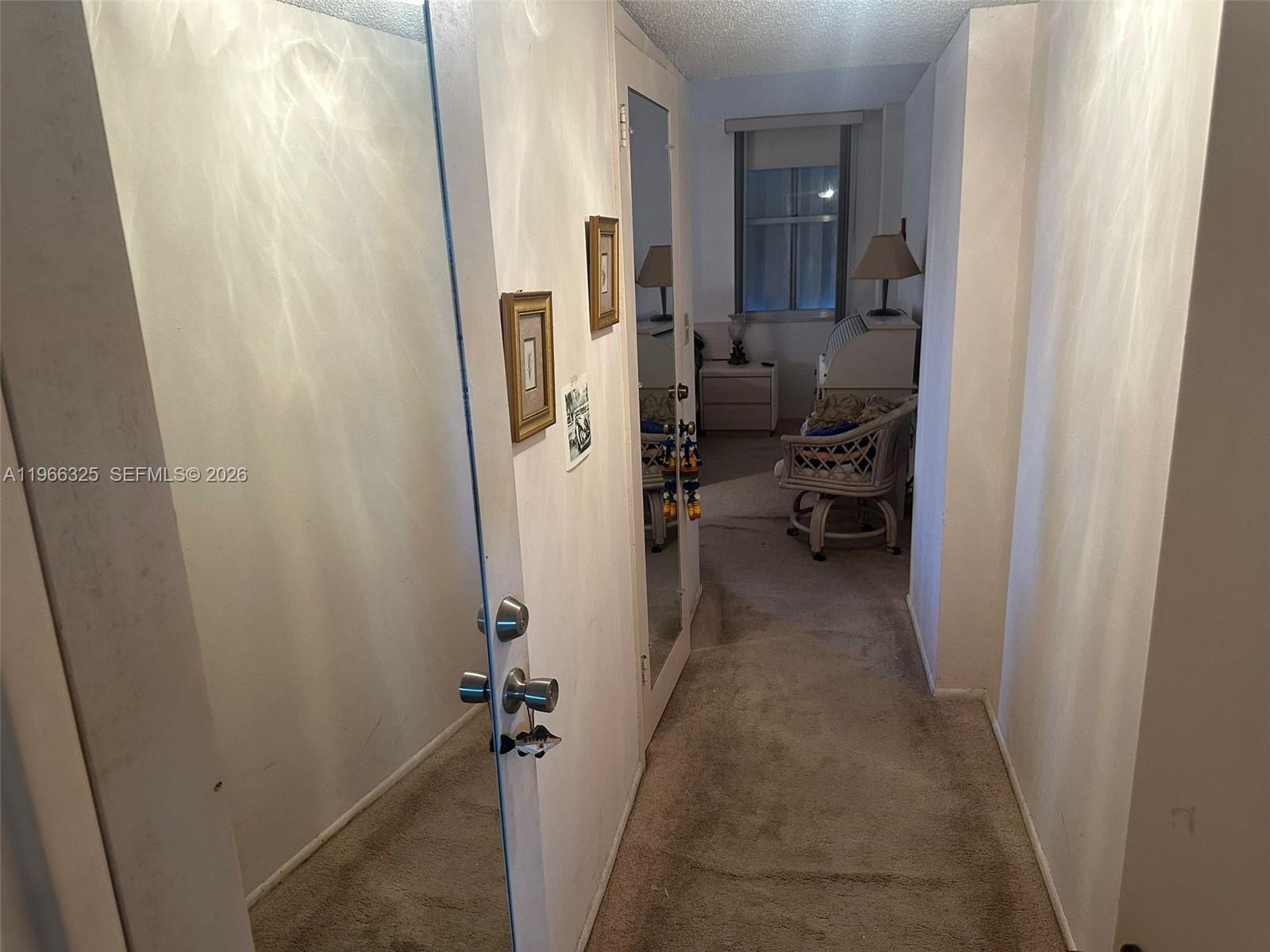 6039 Collins Avenue, Unit 1517 Miami Beach, FL 33140 - Photo 14 of 54 a view of a hallway with living room