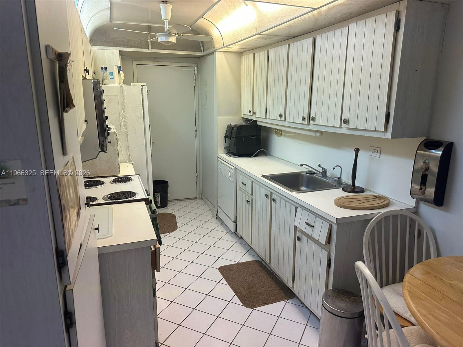 6039 Collins Avenue, Unit 1517 Miami Beach, FL 33140 - Photo 15 of 54 a kitchen with a sink and appliances