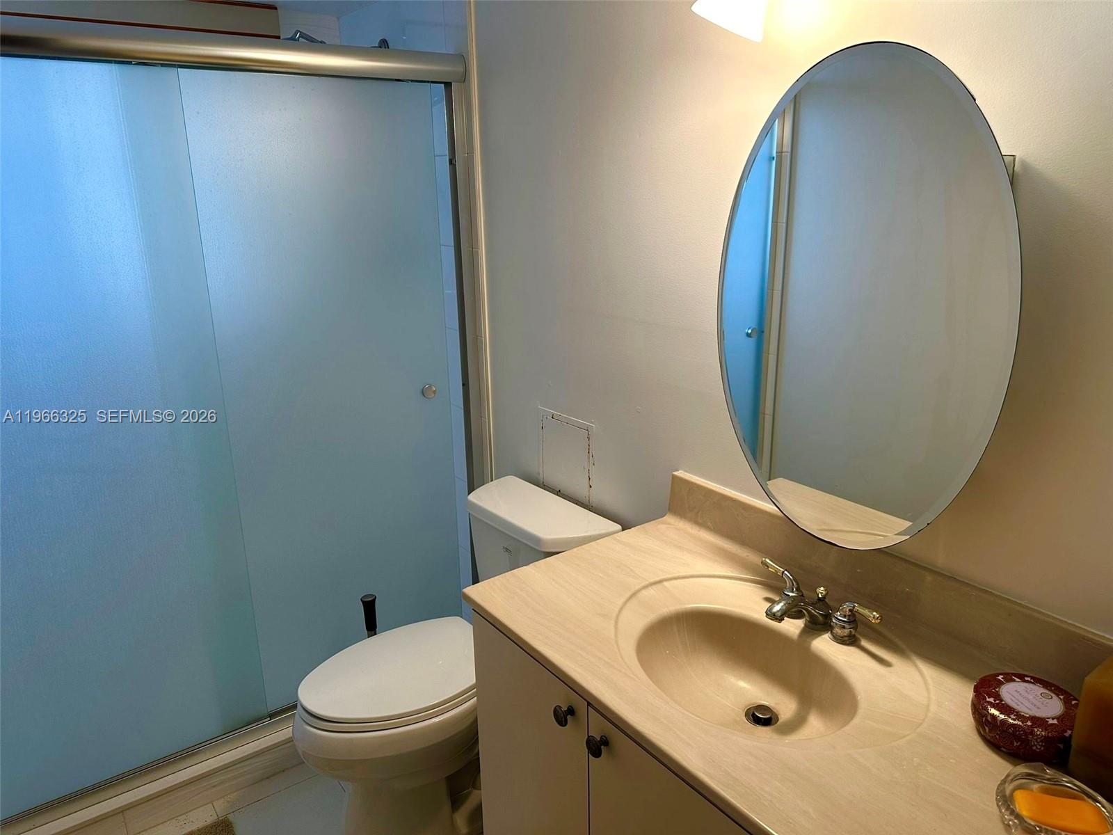 6039 Collins Avenue, Unit 1517 Miami Beach, FL 33140 - Photo 18 of 54 a bathroom with a sink and mirror with toilet
