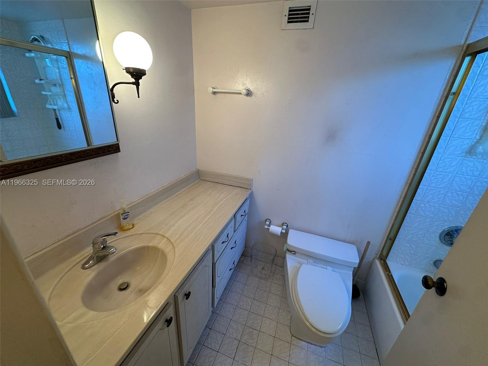 6039 Collins Avenue, Unit 1517 Miami Beach, FL 33140 - Photo 19 of 54 a bathroom with a sink and a mirror