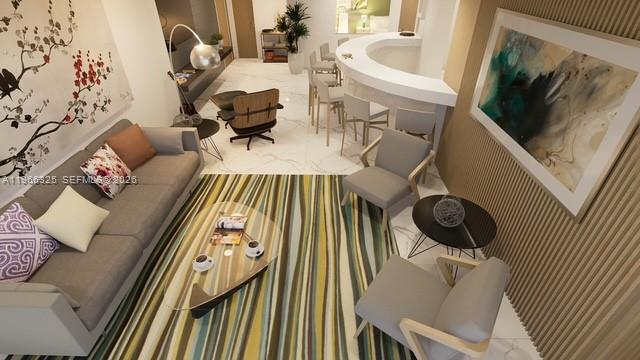 6039 Collins Avenue, Unit 1517 Miami Beach, FL 33140 - Photo 45 of 54 a living room with furniture and a flat screen tv