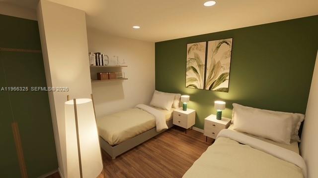 6039 Collins Avenue, Unit 1517 Miami Beach, FL 33140 - Photo 48 of 54 a bedroom with a bed and wooden floor