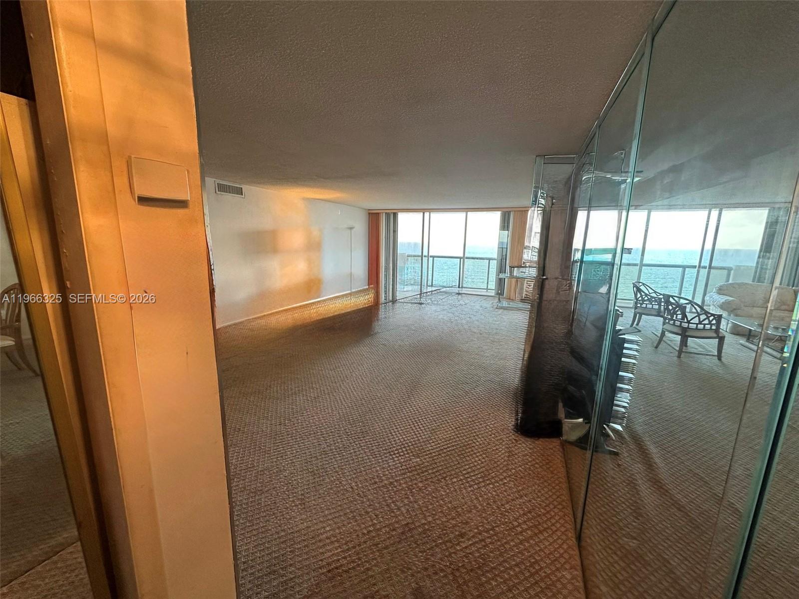 6039 Collins Avenue, Unit 1517 Miami Beach, FL 33140 - Photo 6 of 54 a view of a glass door and an outdoor space