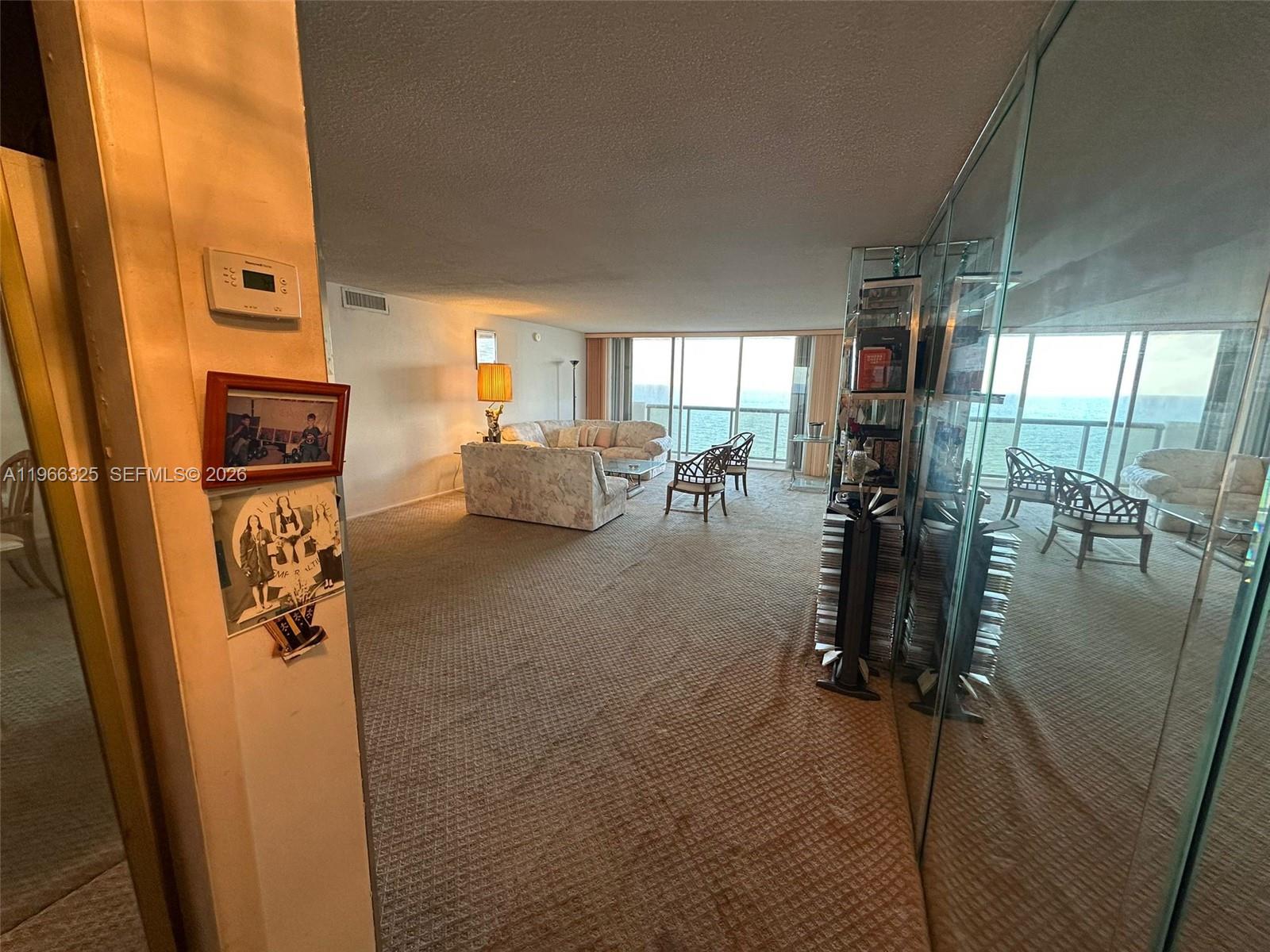 6039 Collins Avenue, Unit 1517 Miami Beach, FL 33140 - Photo 10 of 54 a living room with furniture