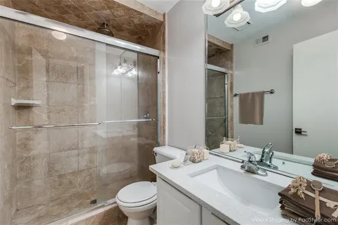 a bathroom with a sink toilet and shower
