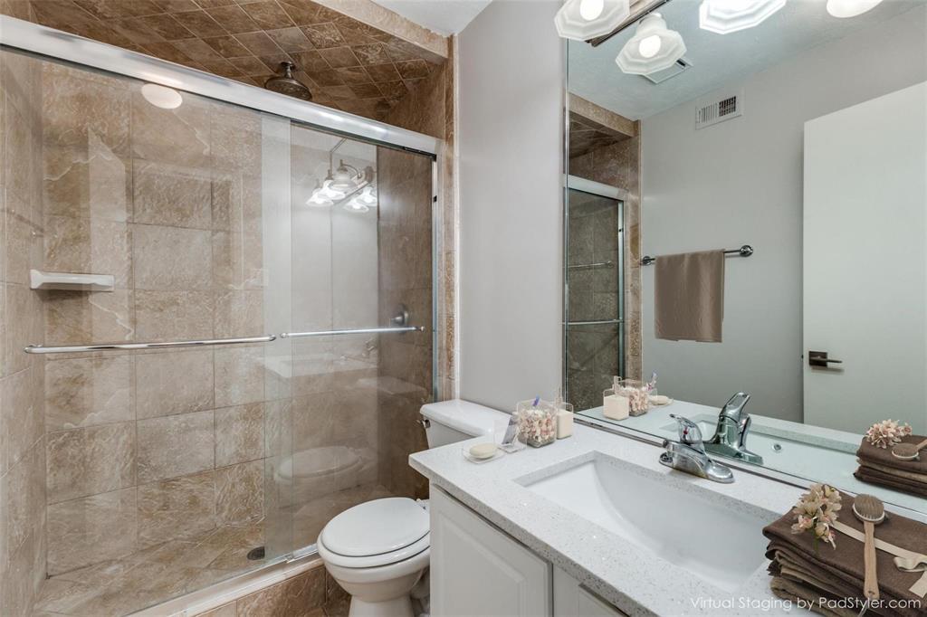 5911 East University Boulevard, Unit 104 Dallas, TX 75206 - Photo 5 of 8 a bathroom with a sink toilet and shower
