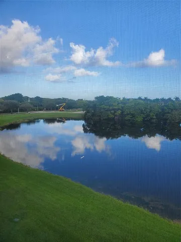 a view of a swimming pool with a yard