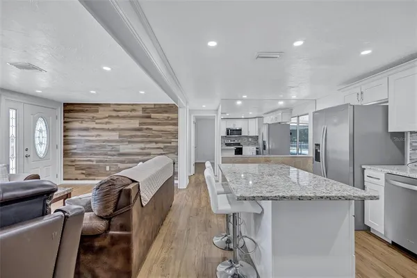 a kitchen with center island and stainless steel appliances