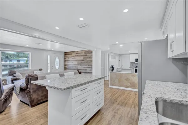 a kitchen with stainless steel appliances granite countertop a sink stove and cabinets