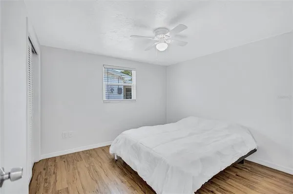 a bedroom with a bed and a chandelier