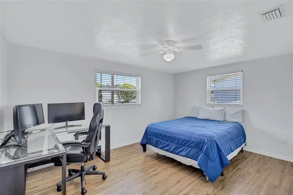 a bedroom with a bed a desk and chair