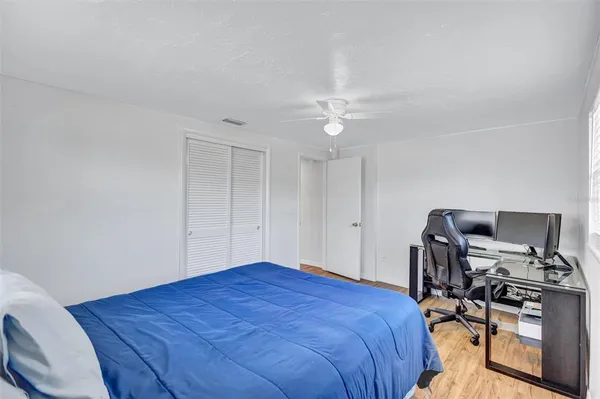 a bedroom with a bed a desk and chair