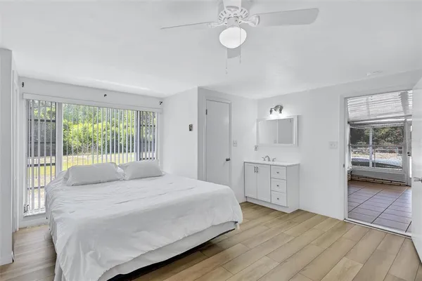 a bedroom with a bed and a large window