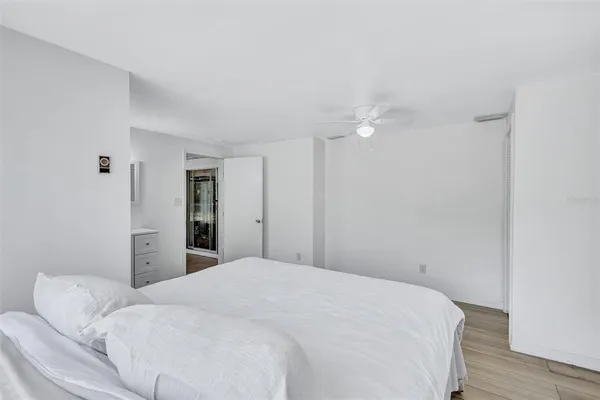 a bedroom with a bed and a ceiling fan