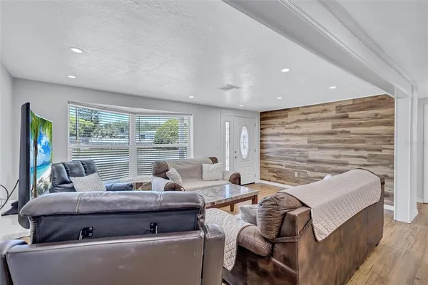a living room with furniture and large windows