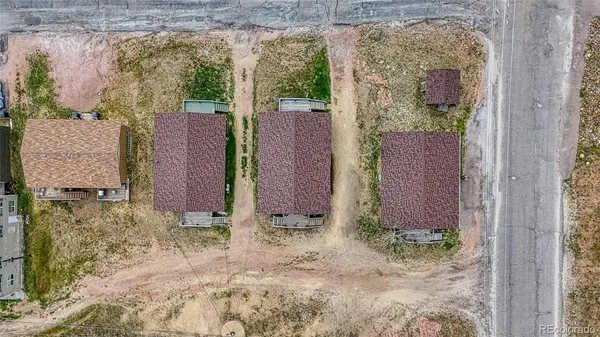 a view of a brick wall next to a yard