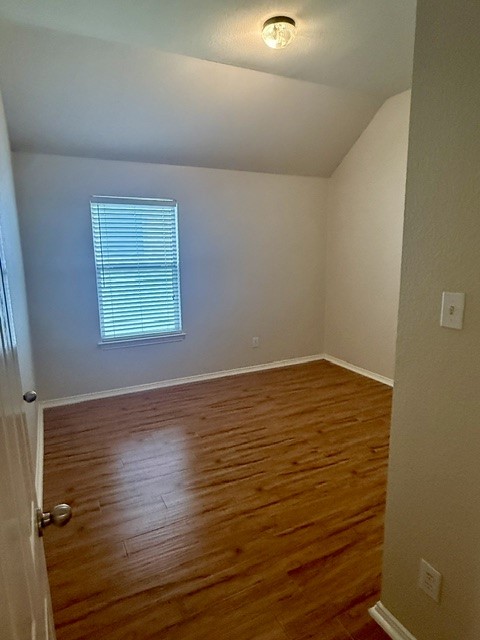 20724 Kearney Hill Road Pflugerville, TX 78660 - Photo 31 of 40 Room featuring wood-finish flooring, a single window with horizontal blinds, and neutral wall paint