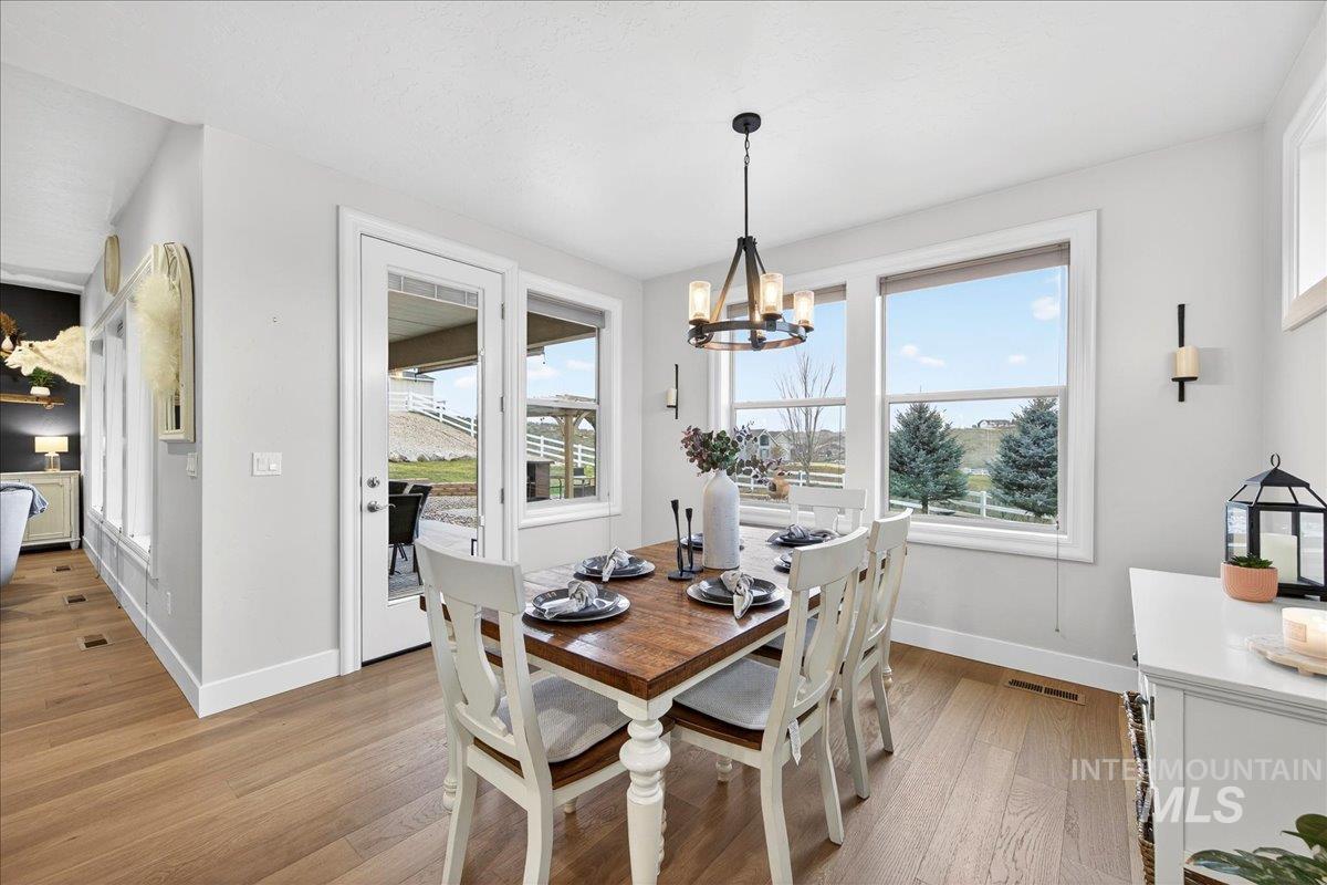 24813 Valley Run Place Star, ID 83669 - Photo 17 of 50 Dining room featuring light wood-style floors and a chandelier