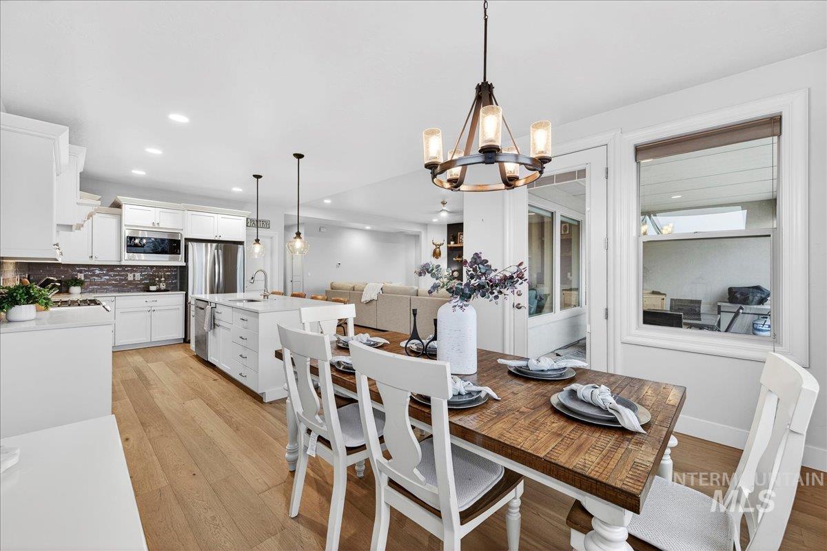 24813 Valley Run Place Star, ID 83669 - Photo 18 of 50 Dining space featuring a chandelier, light wood-style floors, and recessed lighting