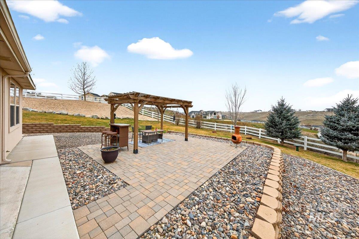 24813 Valley Run Place Star, ID 83669 - Photo 2 of 50 Fenced backyard featuring a patio area, an outdoor fire pit, and a pergola